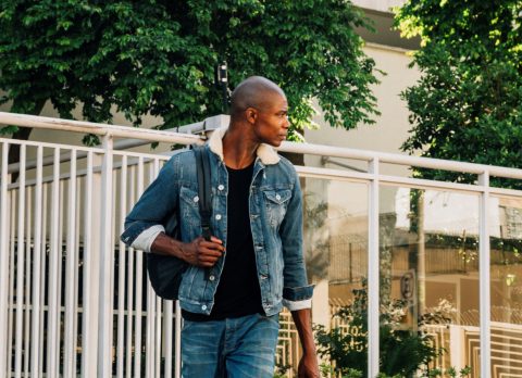 portrait-african-young-man-with-his-backpack-shoulder-looking-away